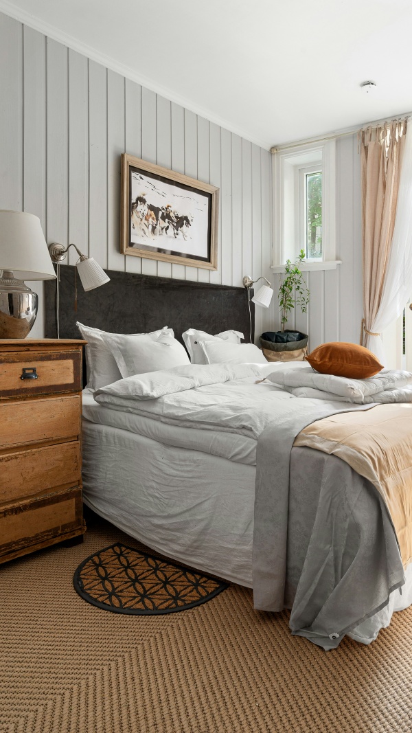 The bedroom at Fell End, with a wrought-iron bed facing a window over the fell