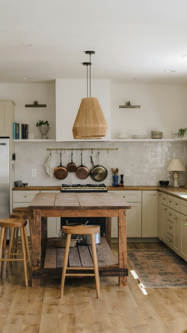 The kitchen at Fell End, with open shelving, a range cooker and a small dining table for two